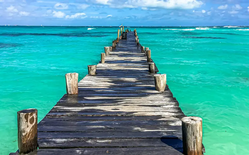 Wooden pier over turquoise water