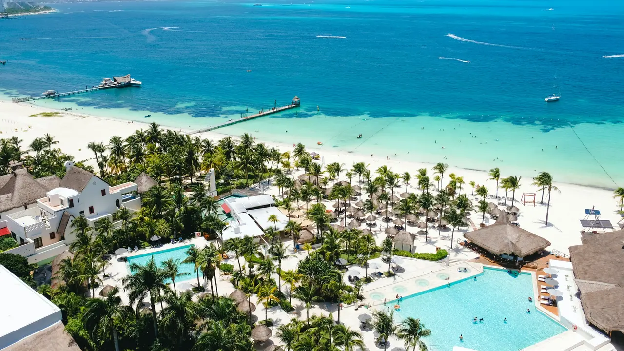 Hotel with pools and palm trees by the sea