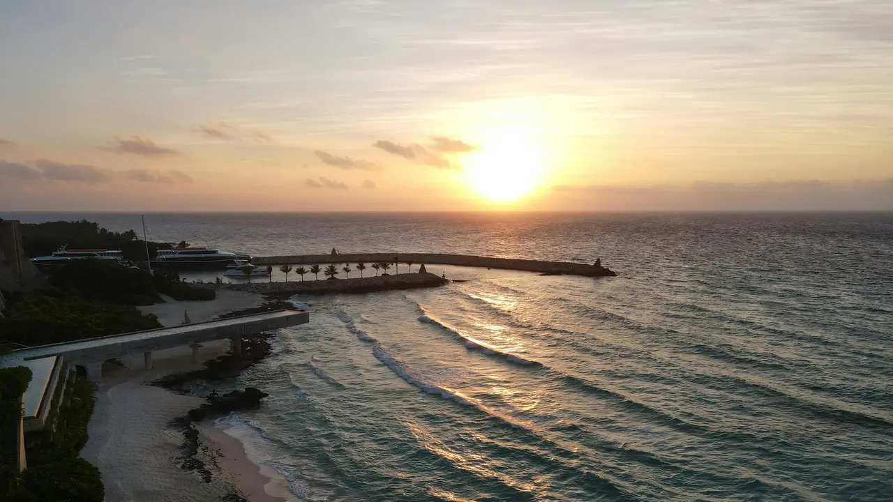Sunset over the Caribbean beside a pier