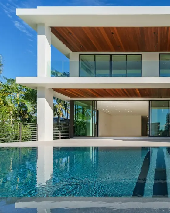 Two-storey modern white house with a lap pool